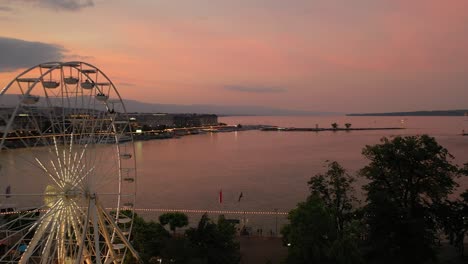 sunset sky night illumination geneva city center lakeside fountain ferris wheel aerial panorama 4k switzerland