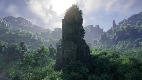 majestic rock formation surrounded by lush greenery in a mountainous terrain