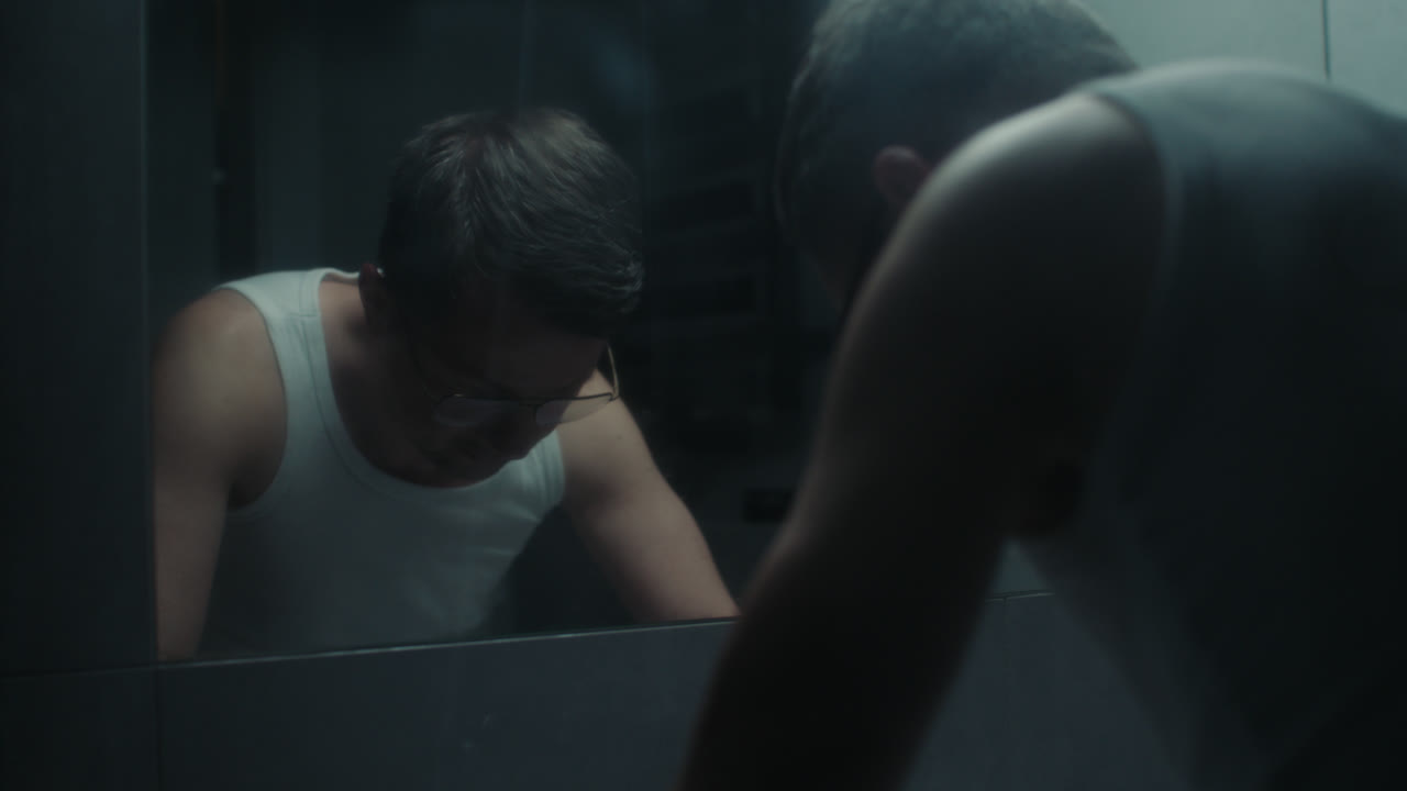 A sad man in the bathroom during his morning routine