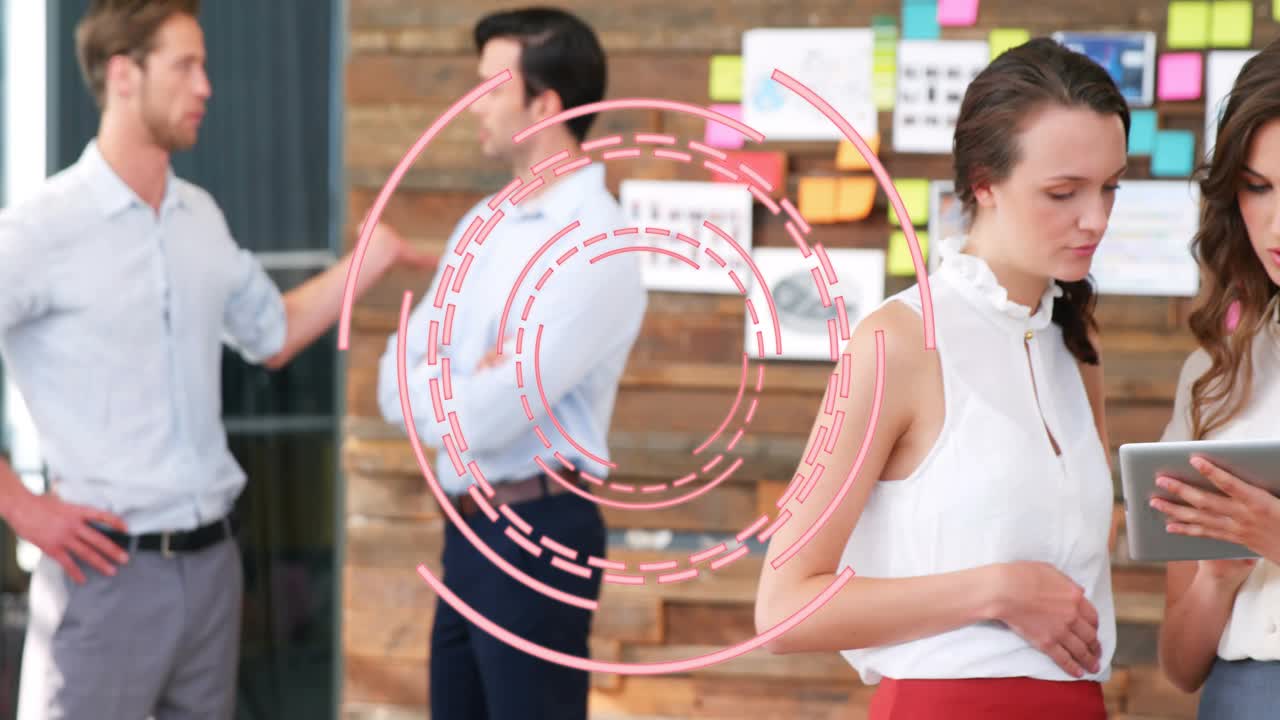 Two women in office scrolling while pink HUD appearing, badges growing around tablet for marketing