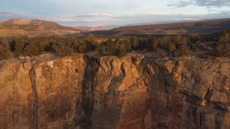 moving shot of drone video pulling away from butte at sunset in colorado