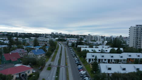 Drone-view-flying-through-neighborhood-of-Reykjavik,-Iceland-capital-city.-Aerial-view-of-streets-and-building-of-world’s-northernmost-capital-city.-Travel-destination.-Wanderlust