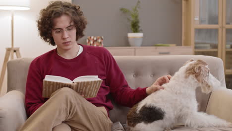 reading young man and fox terrier