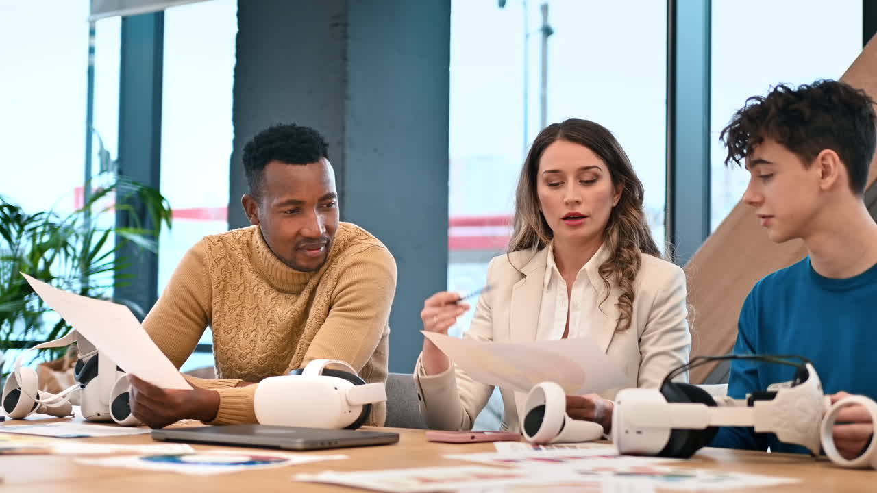 Business conference in VR in an office. Multiracial group of people talking about VR glasses. Slow motion