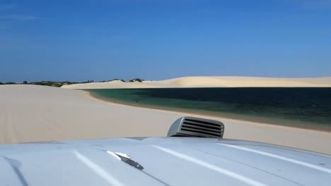 car on the road in the dunes