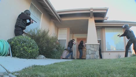 dea officers with arms drawn perform a drug raid on a house 5