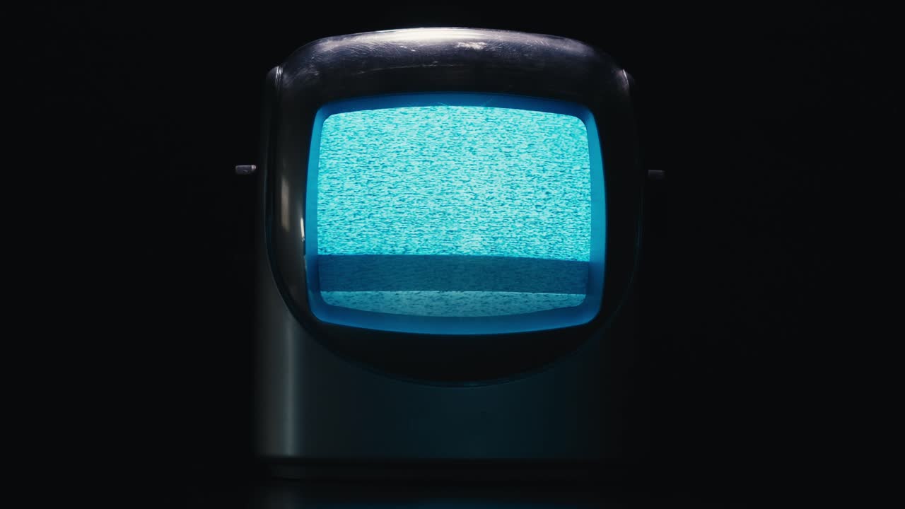 Retro TV, vintage television In a nostalgic setup, a retro TV displays grain on screen, scary halloween night device good for chroma key and green screen. High quality 4k footage