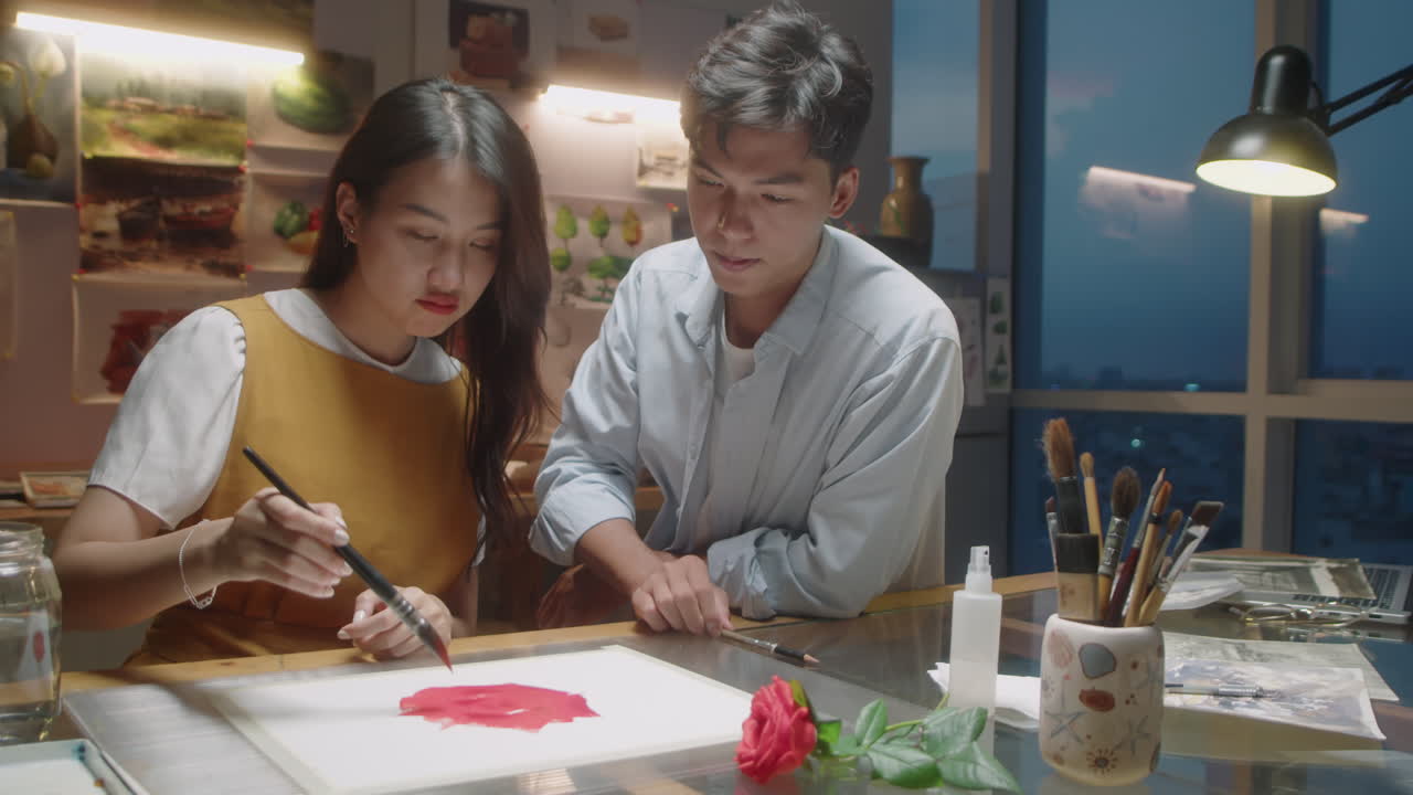 Asian Woman Painting Picture with Teacher on Art Lesson