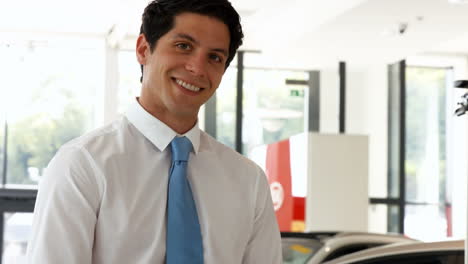 man in a suit signing a document