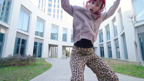 young urban dancer performing outside modern buildings