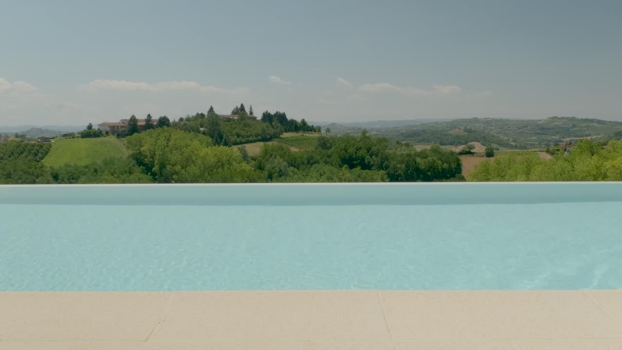 Man walking in front of a beautiful pool in Piemonte Italy