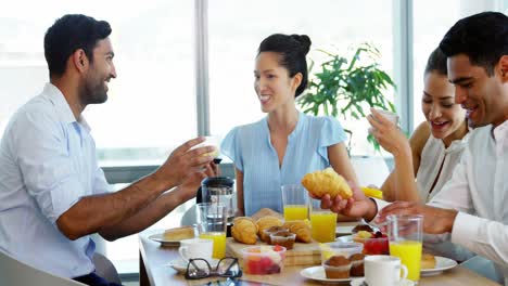 executives having breakfast in the office