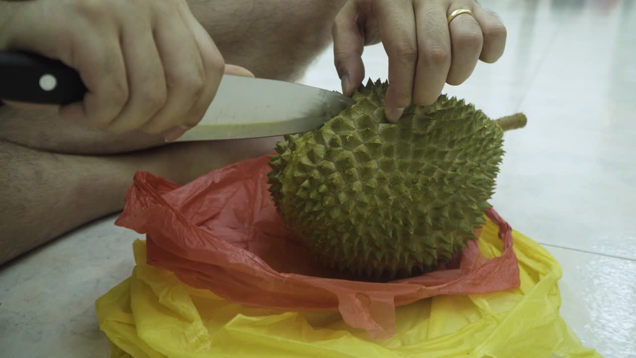Man Slicing And Opening The Mao Shan Wang Durian - close up