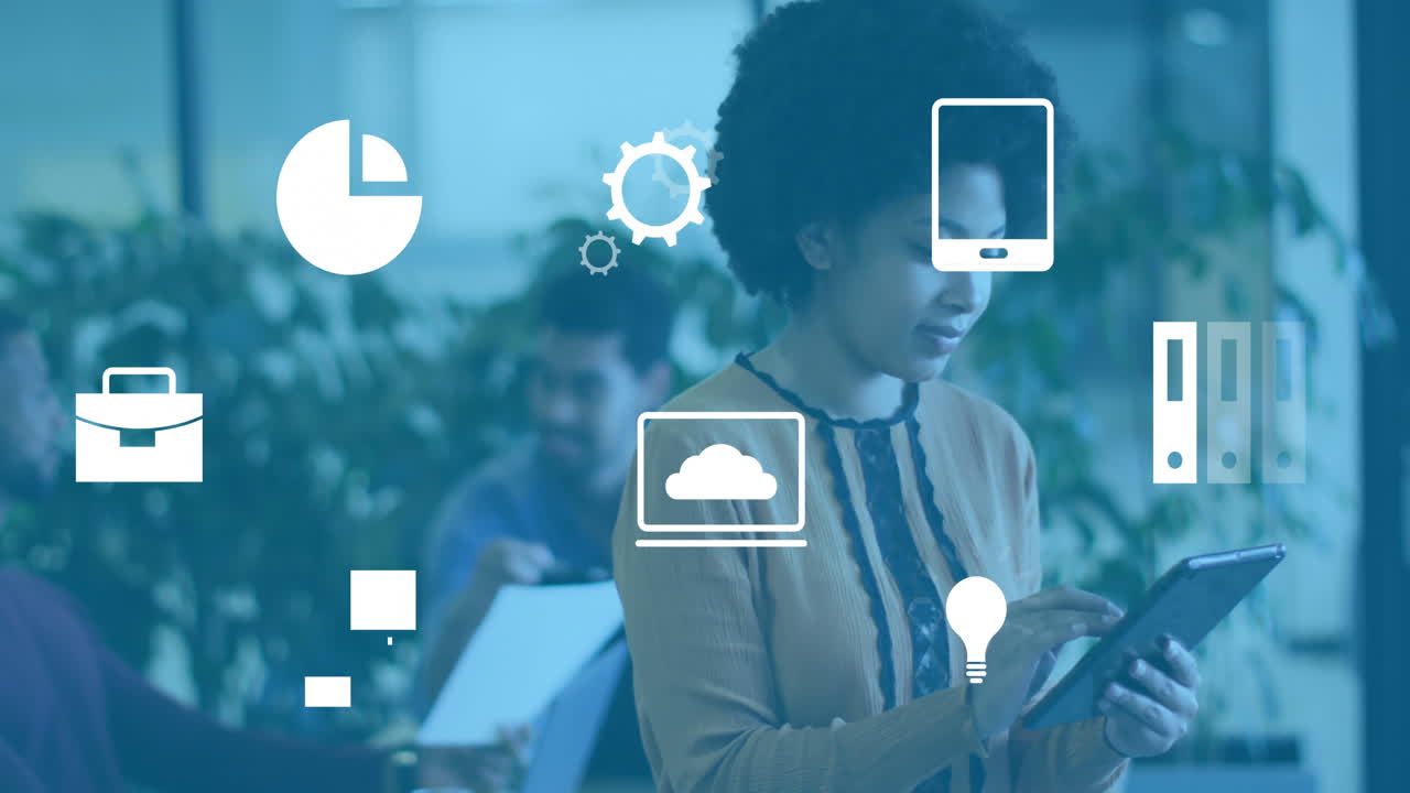 Animation of business icons over diverse colleagues working in office