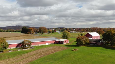 red chicken house and barn set among rural farmland in lancaster county pennsylvania