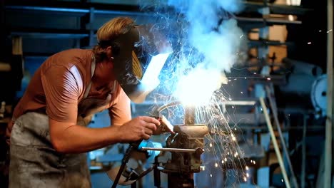 Blacksmith-using-a-welding-torch-in-workshop-4k