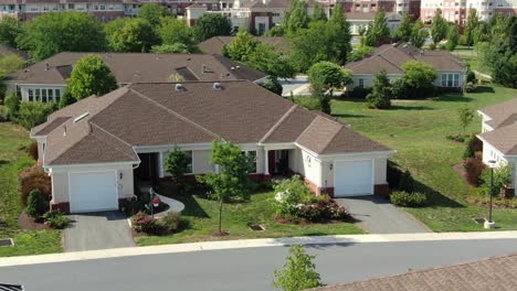 american retirement home community in pennsylvania usa, assisted living tilt down aerial to single-story independent living house, modern home along street