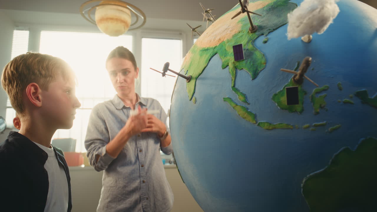 STEM Science Lesson Primary School Children Studying Renewable Energy and Ecology Using Globe