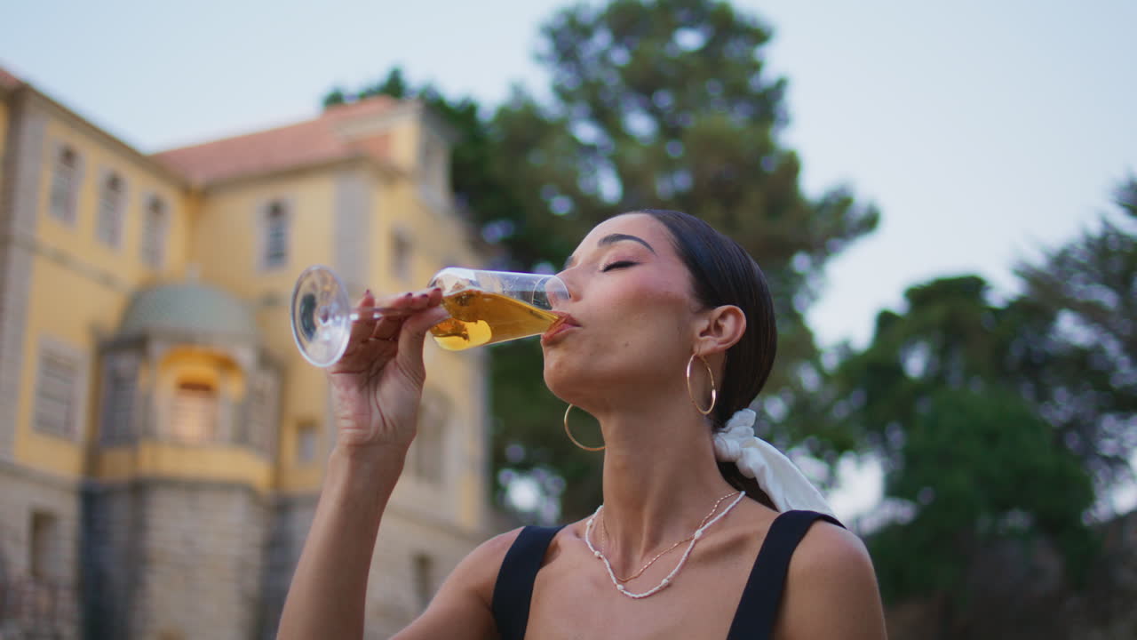 Woman enjoying a drink in a beautiful garden setting