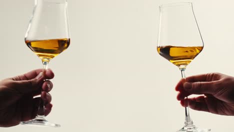 orange or white wine bottle and glass against a sunset in a peaceful vineyard, pouring of ecological natural wine.