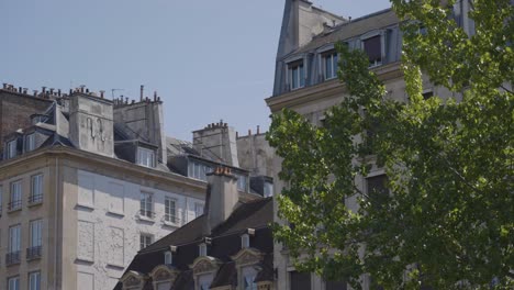 close up of apartment blocks on ile saint louis paris france viewed from river seine in slow motion