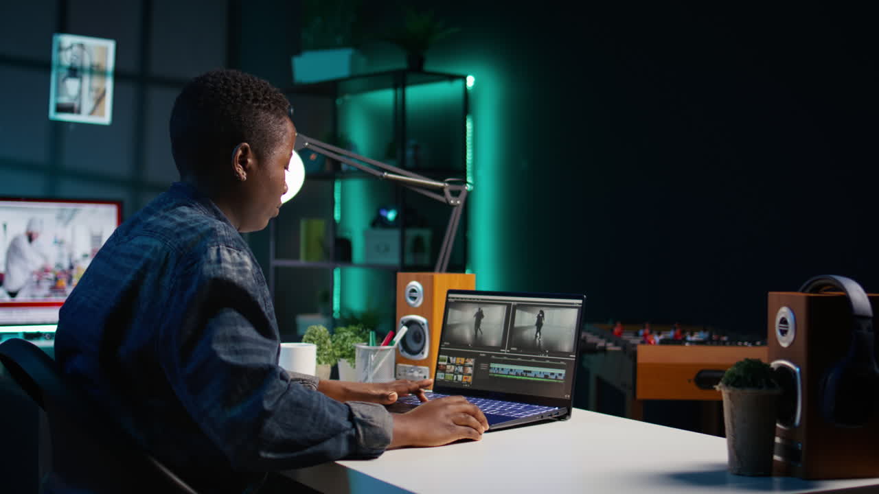 Young Person Editing Video on Laptop at Night