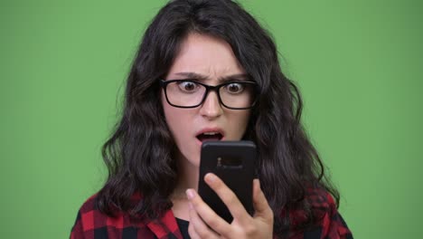 young beautiful businesswoman using phone looking shocked