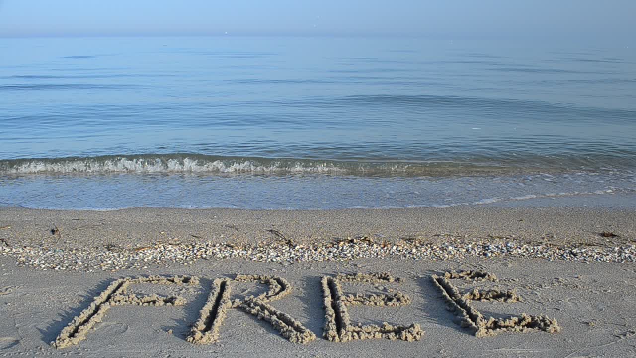 Inscription free on sand, the beach. Inscription on sand