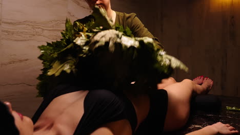 Woman receiving herbal body treatment in a spa