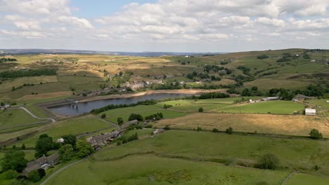 aerial drone video, footage of a rural yorkshire village with a mill chimney