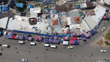 an aerial shot of the city of erbil showing the ancient erbil citadel and the garden opposite the castle with water fountains and the popular market