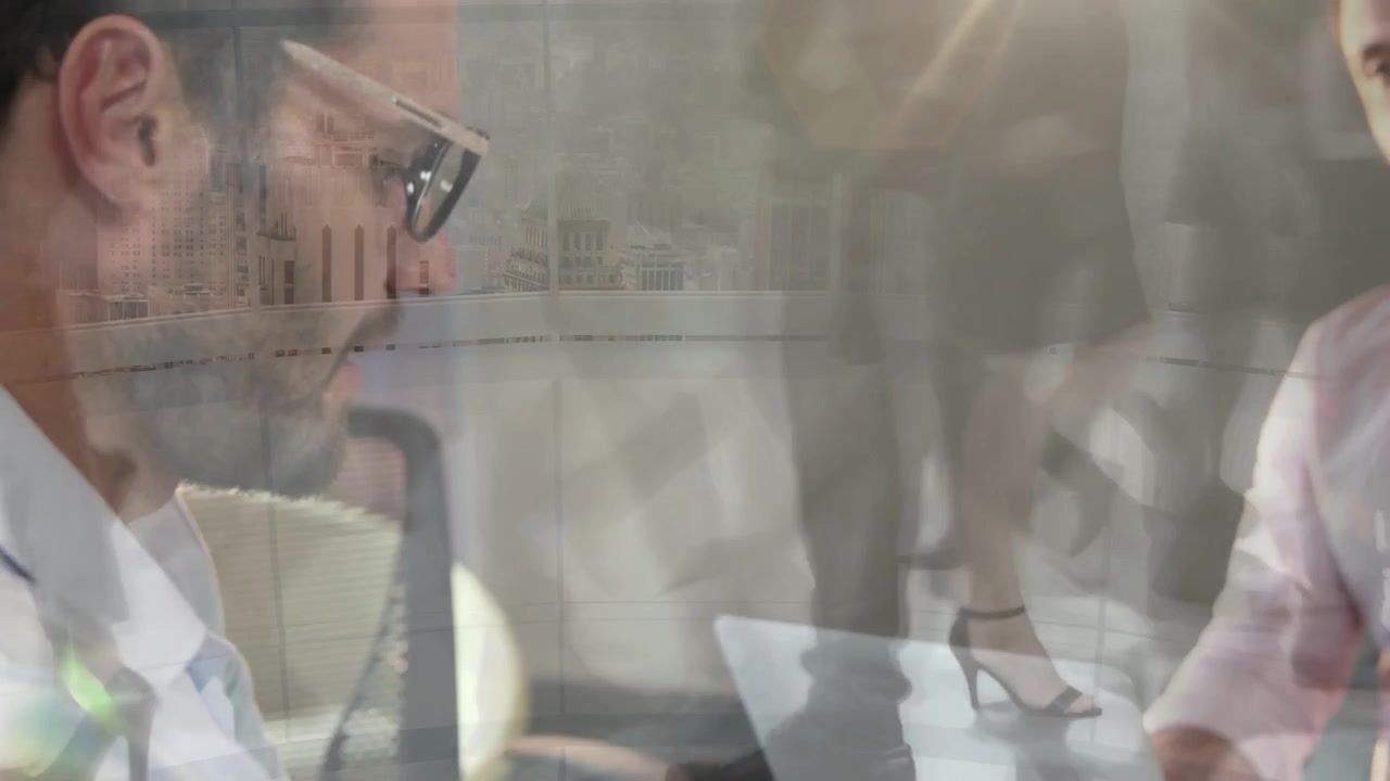 Right man tilting tablet, left man reviewing business charts, shadows crossing glass rising, fading