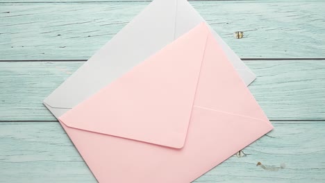 pink and purple envelopes on wooden background