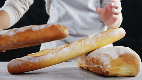 woman arranging loaf of bread on wooden table 4k