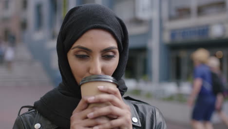 portrait of young beautiful muslim woman drinking coffee enjoying relaxed urban lifestyle