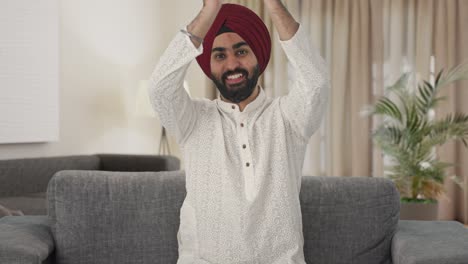 hombre indio sikh feliz aplaudiendo y apreciando