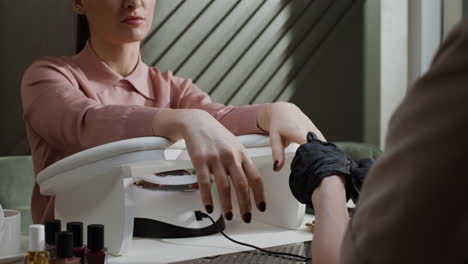 woman getting a manicure at a nail salon