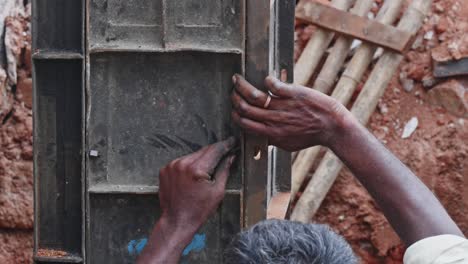 person using nut bolt for installing column formwork at construction site. day time, stable shot, close-up shot, 4k