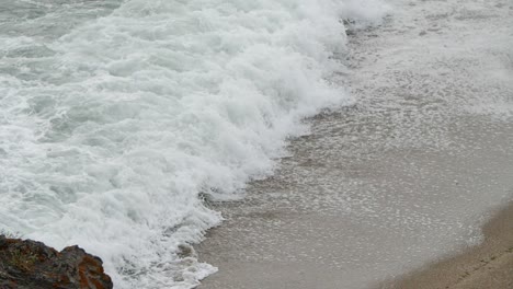 wave foam with tele lens in slow motion