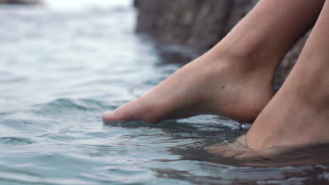 Feet-of-woman,-dip-in-ocean-or-sea-on-vacation