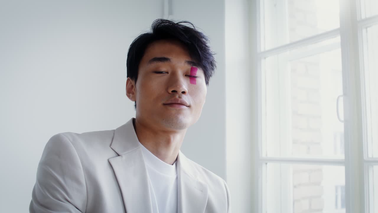 Portrait of a man with tape on his face