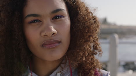 close-up-portrait-of-young-mixed-race-woman-looking-pensive-vulnerable-running-hand-through-afro-hair