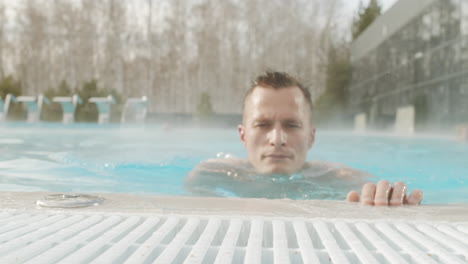 man relaxing in a hot tub