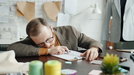 fashion designer working on sketches in studio