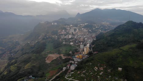 Wide-Slow-moving-Aerial-Dolly-over-the-mountain-town-Sa-Pa,-Vietnam