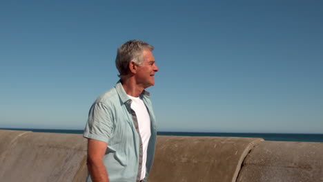 Senior-man-walking-along-the-pier