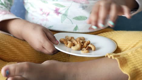 child eating cashews