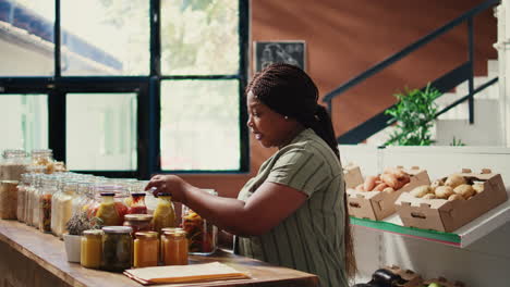 client pouring pasta in reusable paper bags at zero waste store