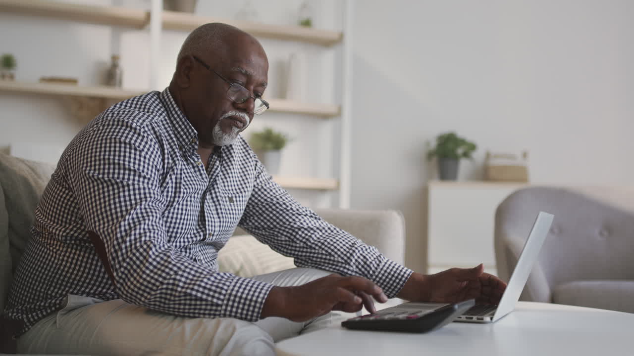 Senior Man Working on Finances at Home