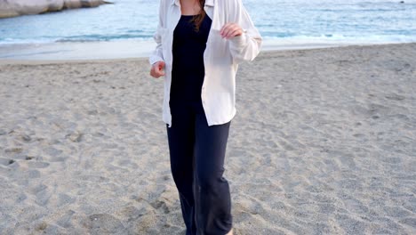 Casual-girl-dancing-on-beach-barefoot-in-Tenerife-island